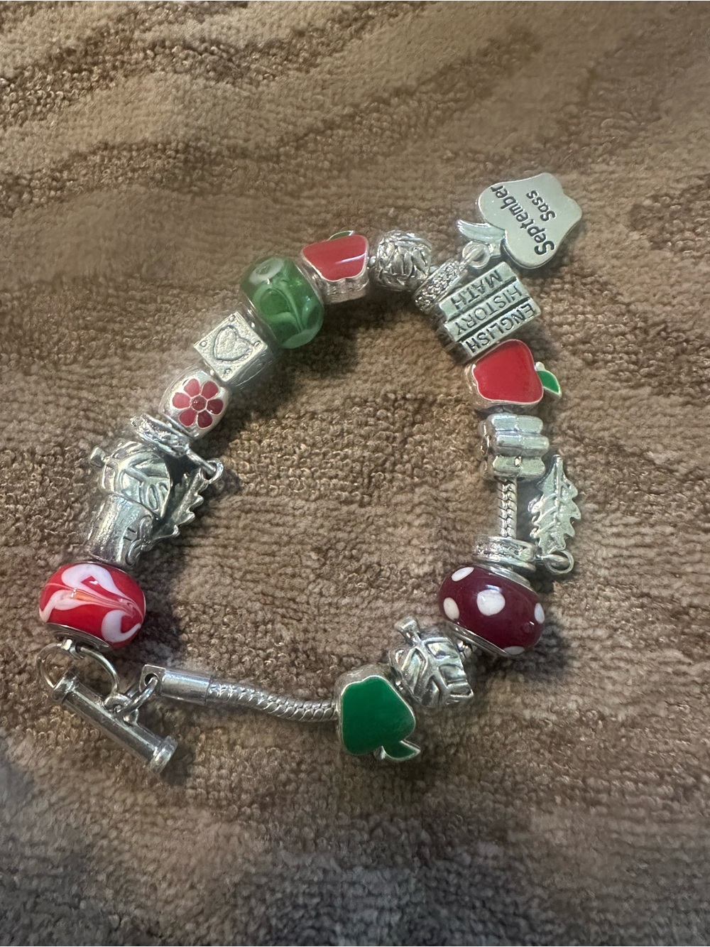 Sterling Silver Charm Bracelet with Red and Green Enamel Accents for September.